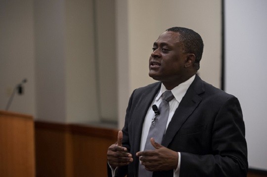 Forensic pathologist Bennet Omalu at a lectern, speaking at theWinston Center for Leadership and Ethics’s Chambers Lecture Series.
