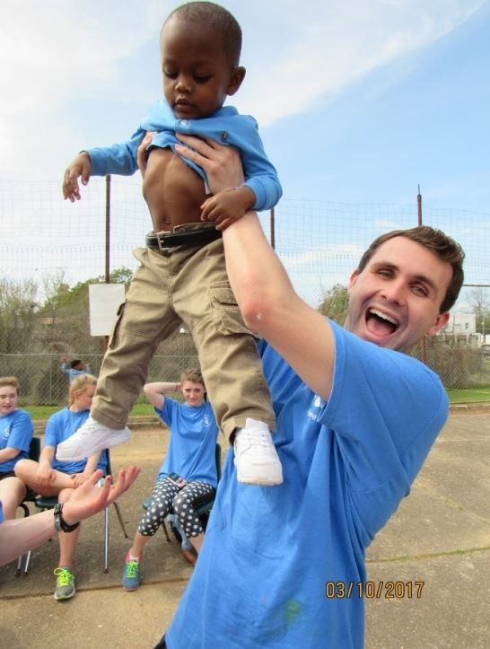 BC student holding a small child