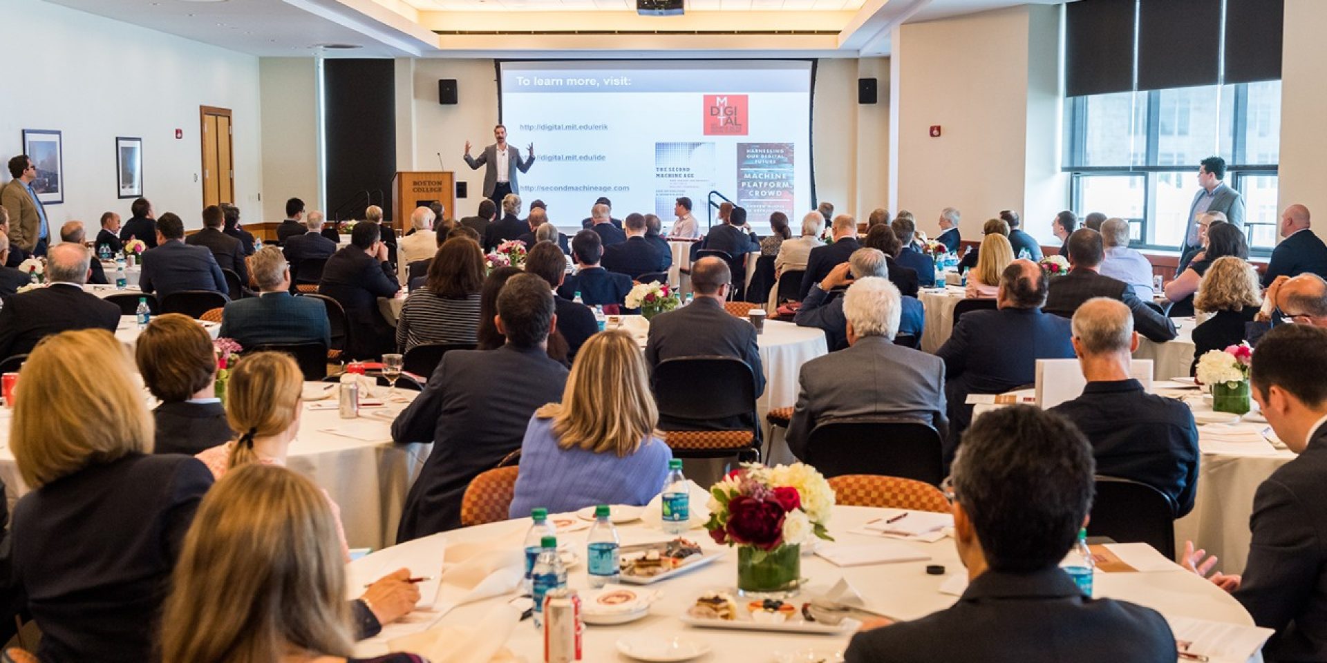 Attendees at the Finance conference watch a presentation