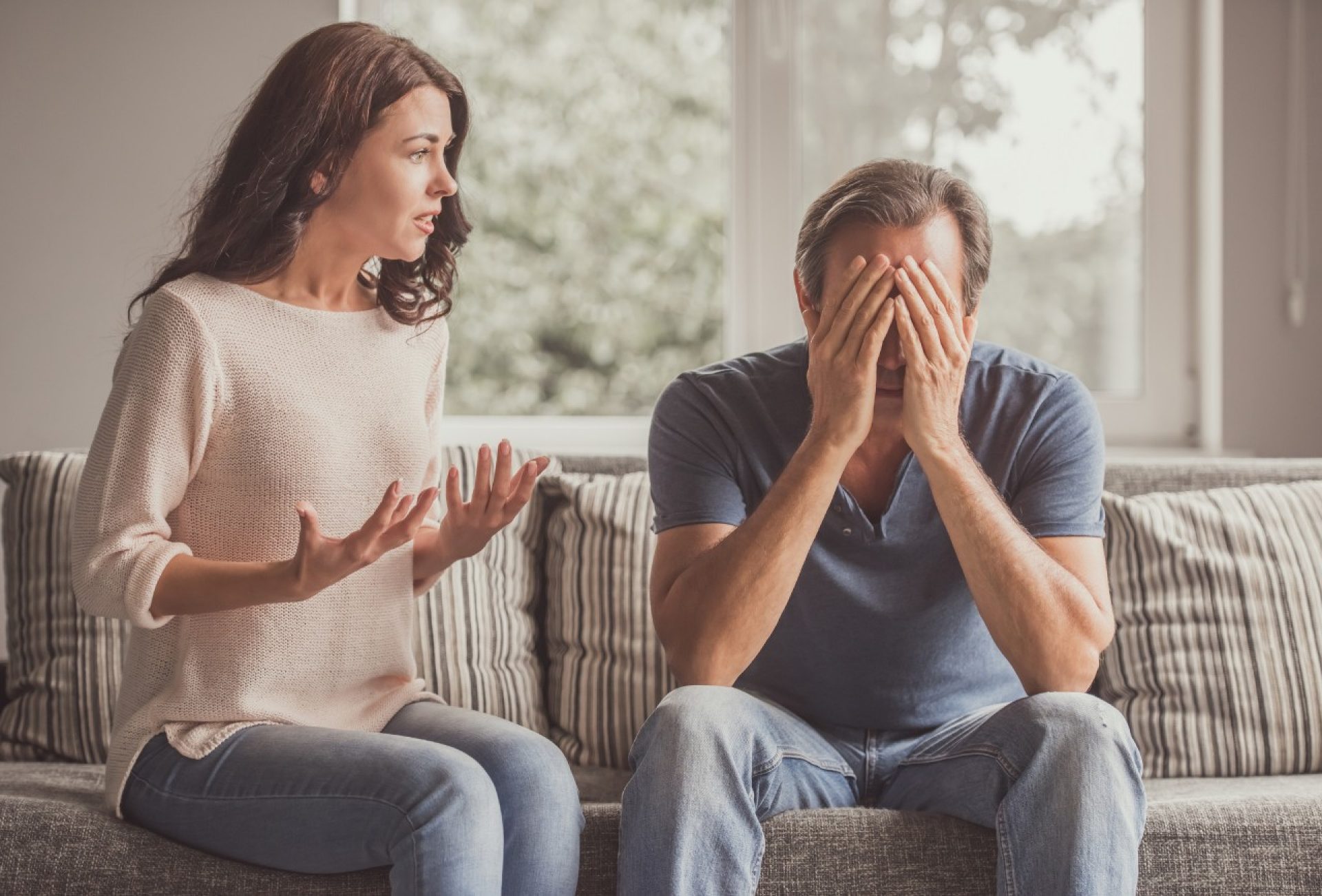 Couple arguing on couch