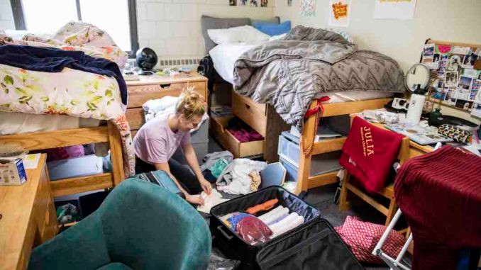 Boston College student packing their dorm room to move out due to coronavirus dorm closures