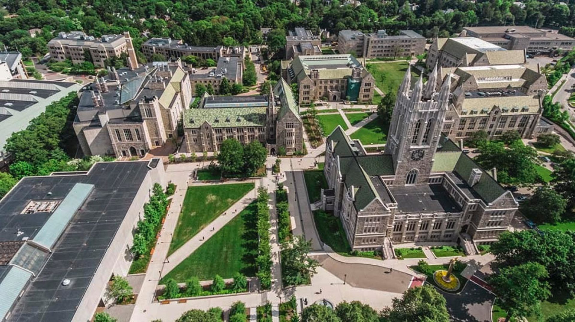 Aerial view of Boston College's campus with students crossing the quad