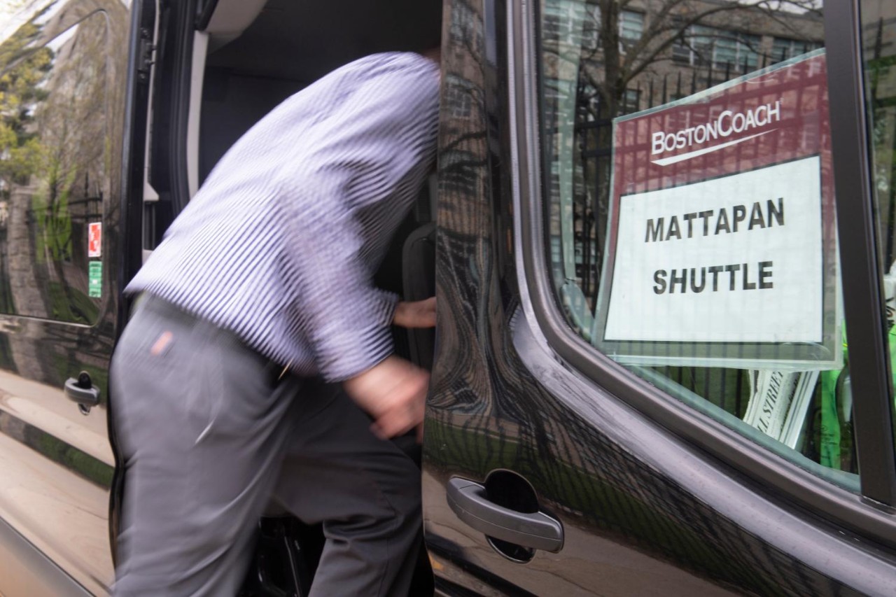 Man climbing into chartered van 