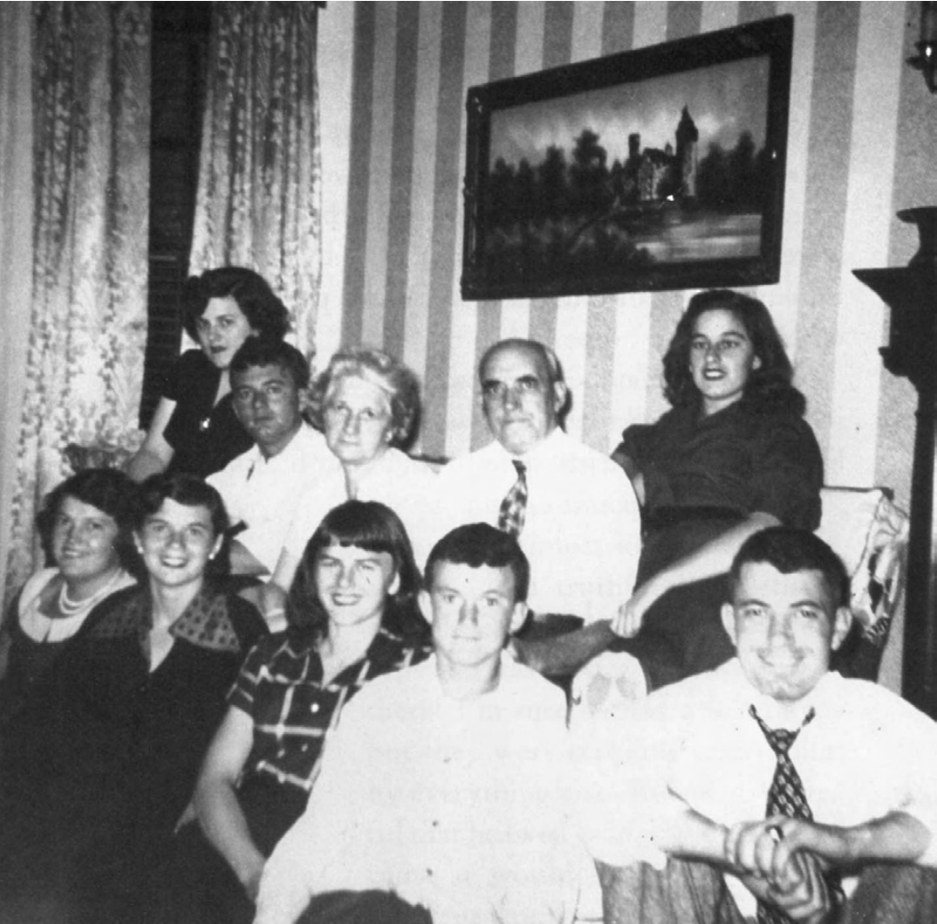 Black and white photo of the Corcoran family with all eight siblings