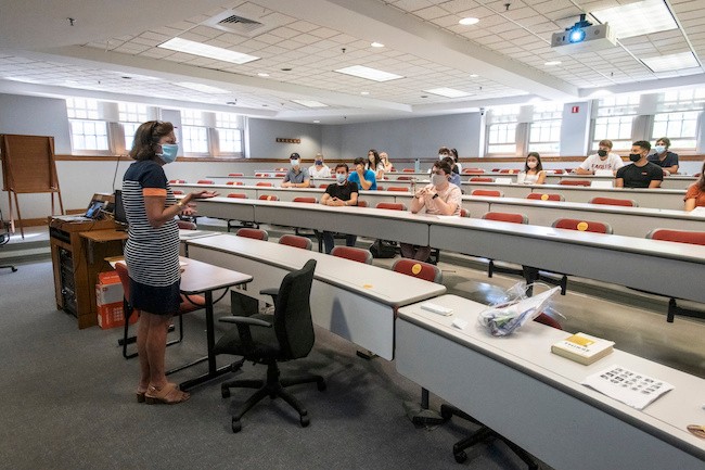 masked students in a socially distanced classroom