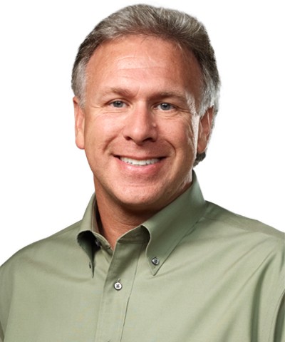 Smiling, gray-haired man in open-collared button-up shirt