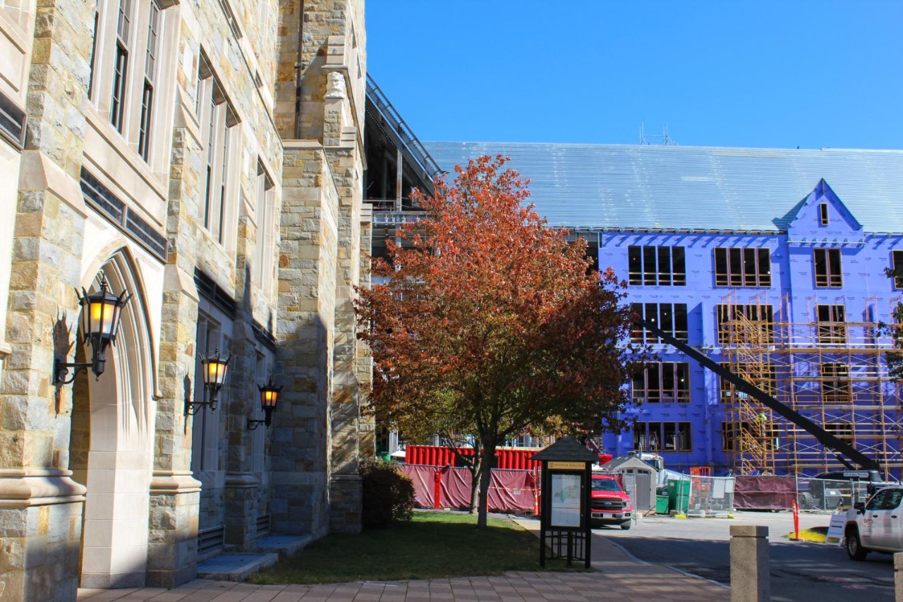 Building under construction behind academic building