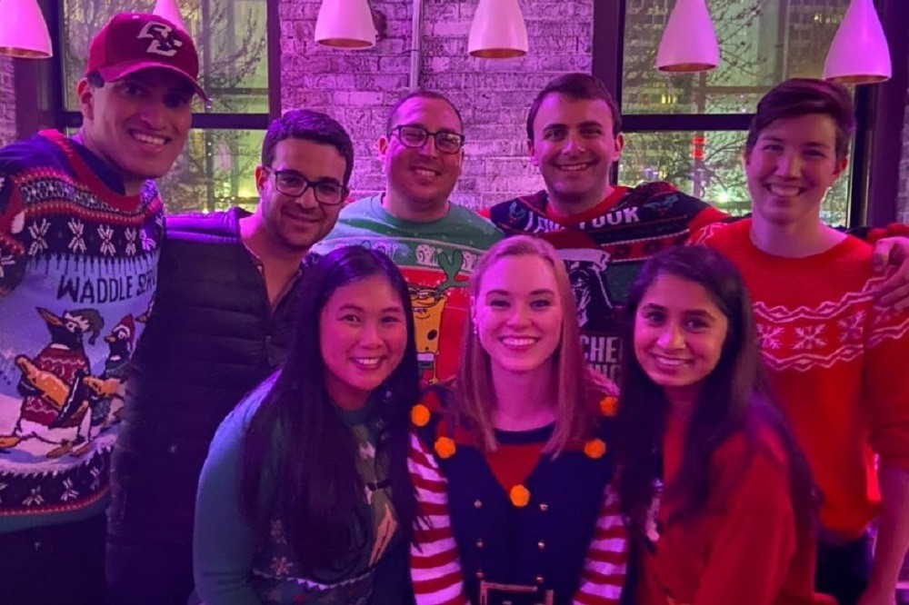 Graduate students in holiday sweaters 