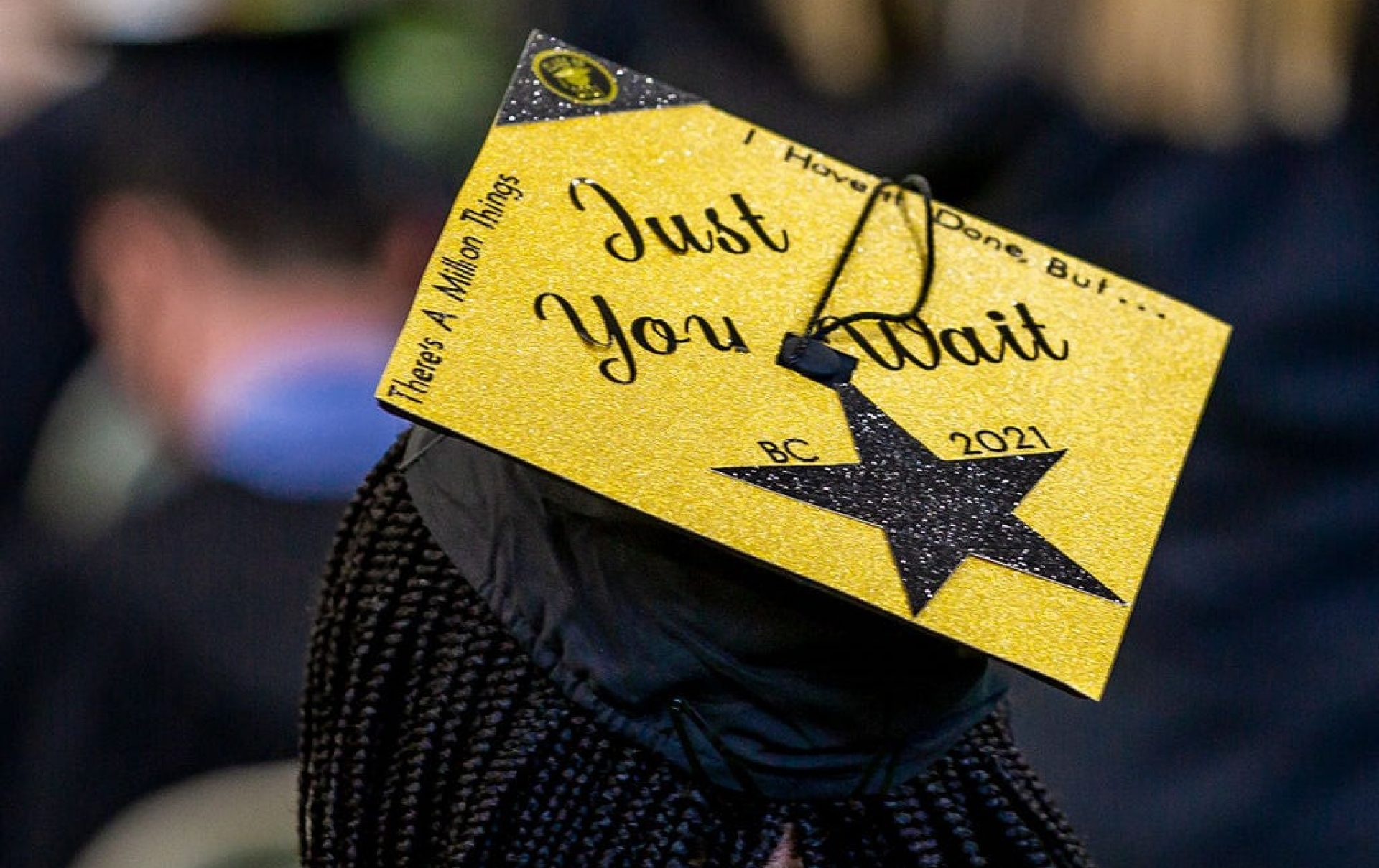 A graduation cap decorated with gold paper reading "Just You Wait" 