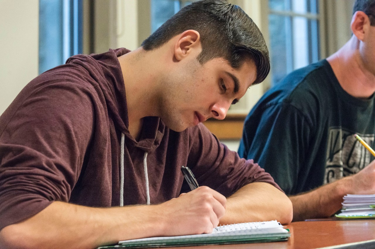 A Portico class taught by Ethan Sullivan, Assist. Dean for Undergraduate Curriculum, and Chairperson of the Honors Program in CSOM. Class was photographed for a marketing project for CSOM. Three students were interviewed for the project, and they first appear in images 001 (woman with glasses), 008 (woman in stripes), and 041 (man with glasses).