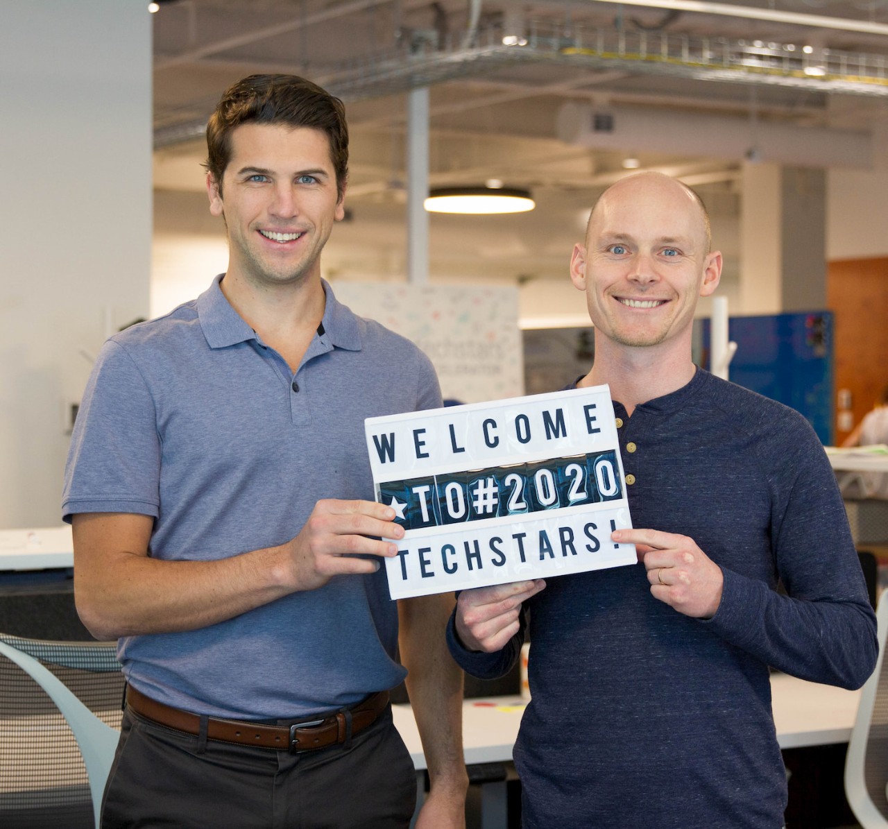 Photo of Wunderite co-founders Joe Schnare, MBA’19 and Peter MacDonald, MBA’19 holding a sign that says Welcome to #2020 Techstars
