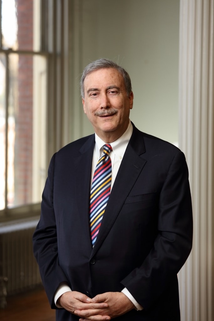 Headshot of Larry Sabato, a smiling white man in a suit