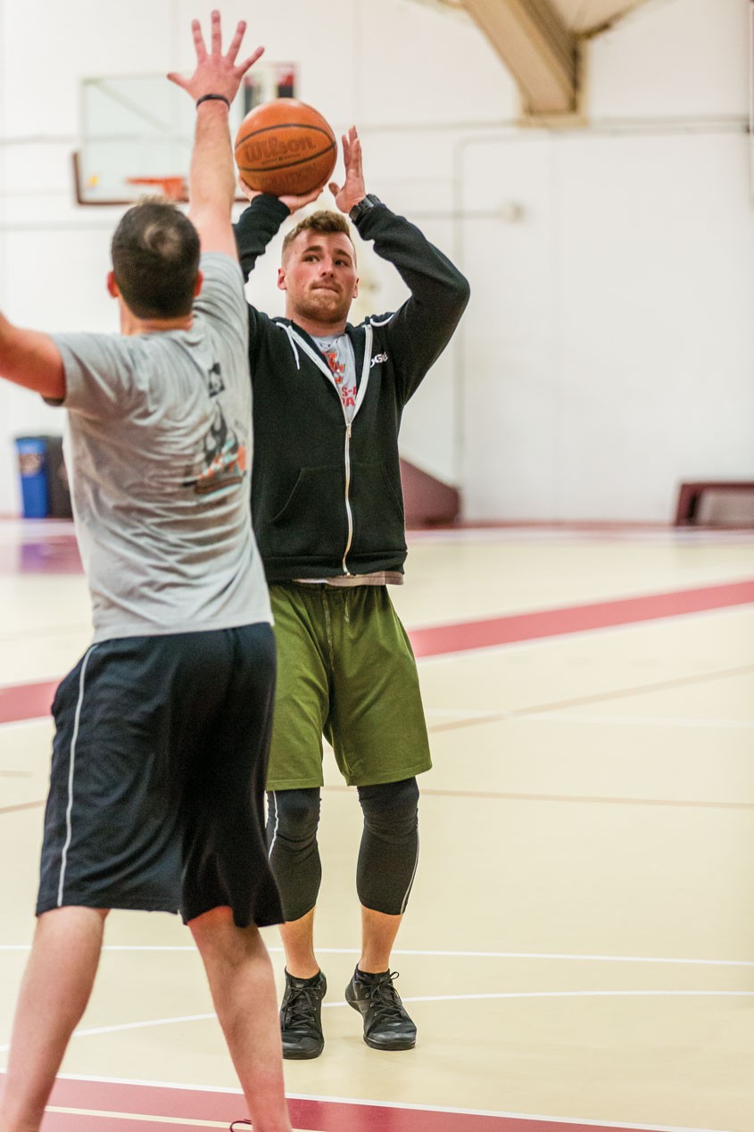 All the veterans and Boston College students, including Tim Joy '16, play basketball during a cardio workout