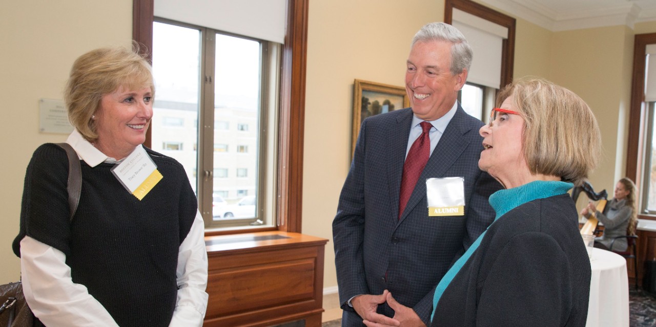 Tracy Burnett Brown '80 and Scott Brown '79 talk with Dean Susan Gennaro