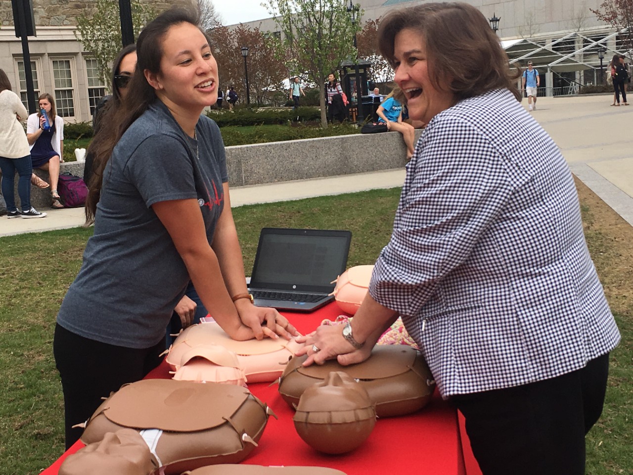 Sydney Conti demonstrates compressions to a passing faculty member
