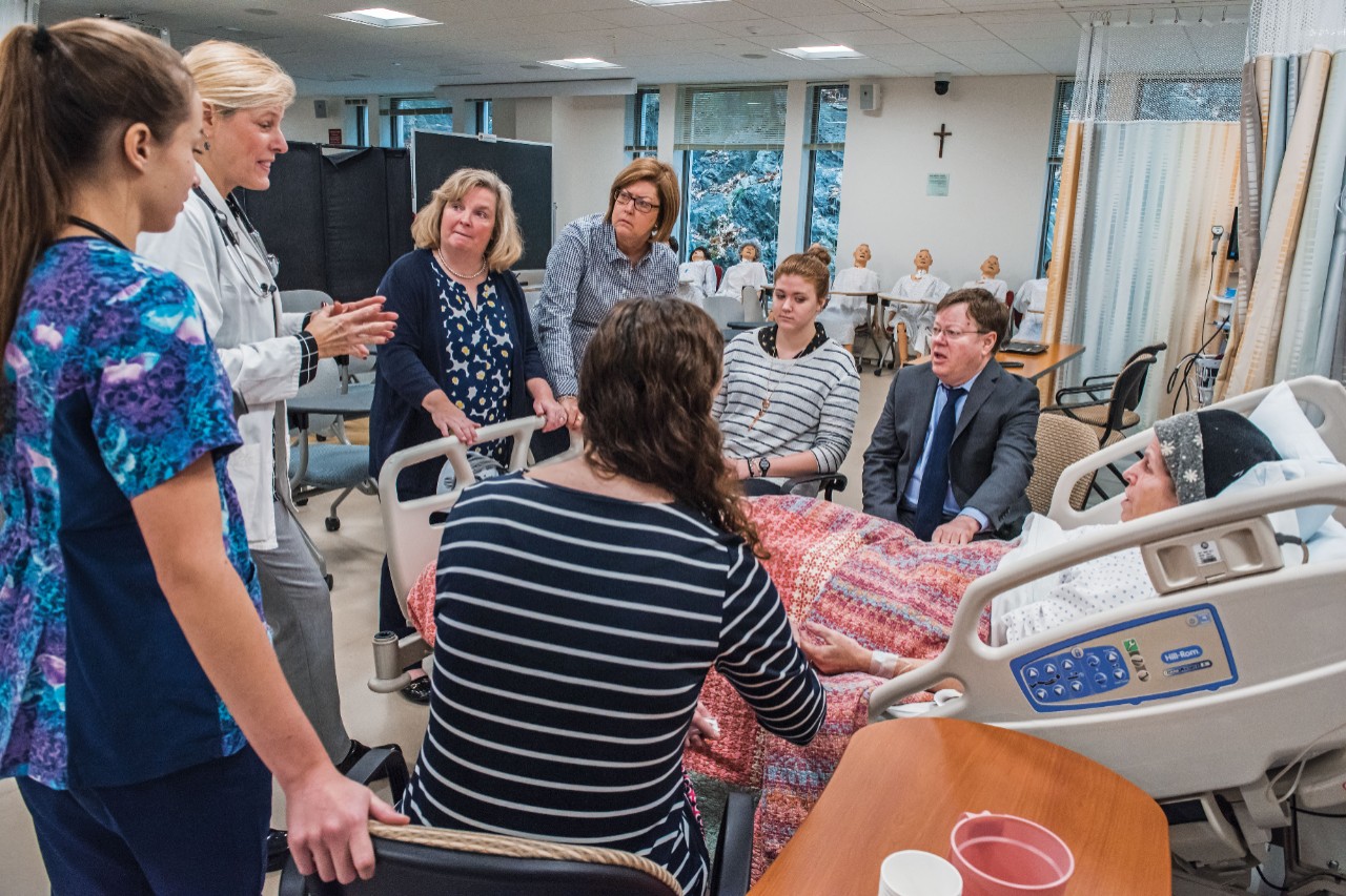 A conference before the students arrive. Clockwise from left: Contino (in floral scrub), Zlevor, Smith, Cullinan, Lawler, Ross, Sullivan, and Gribaudo. 