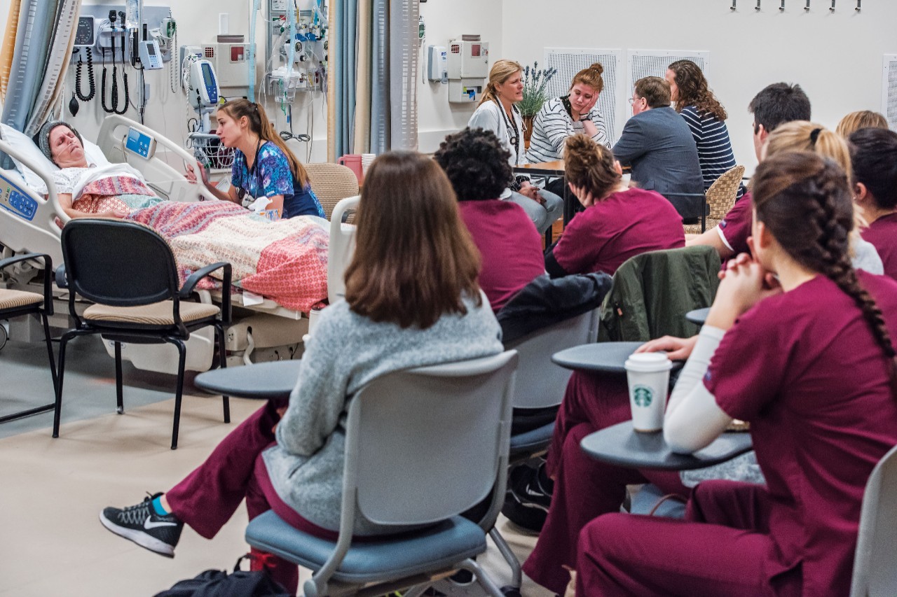 Zlevor consults with Marybeth’s family (upper right) as, at left, Contino monitors the patient