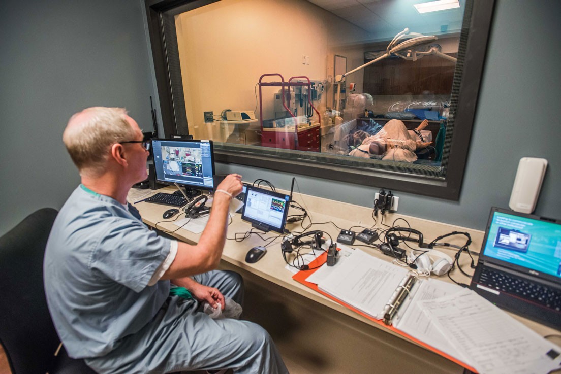 Nurse Anesthesia Clinical Instructor Allan Thomas in the sim lab control room.