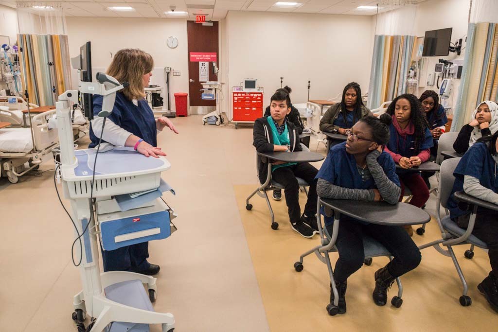 An instructor demonstrating equipment to a group of students