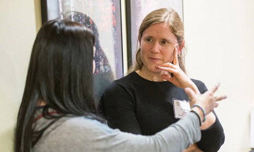 Professor Mary Holper talking with student