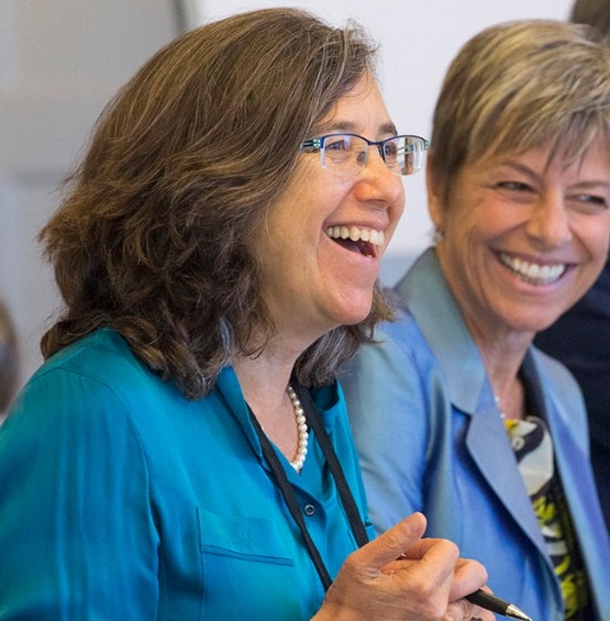 A student smiling with colleagues