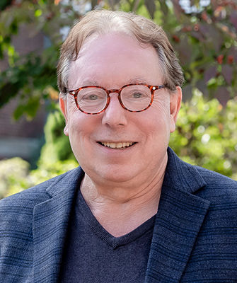 Professor Dan Kanstroom, with background image from WBUR's article on immigration
