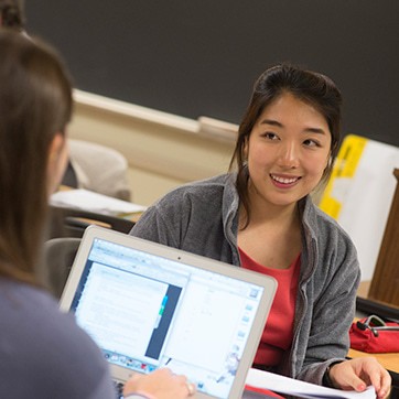 A student smiling with colleagues