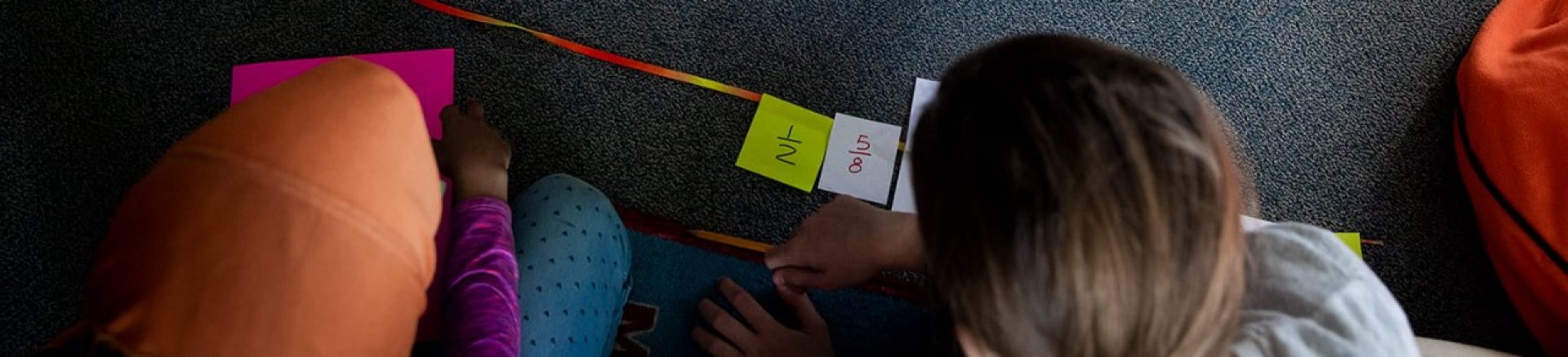children looking at cards on the floor