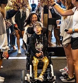 A student in a wheelchair entering a building