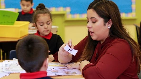 Teacher speaking with two students in a small group