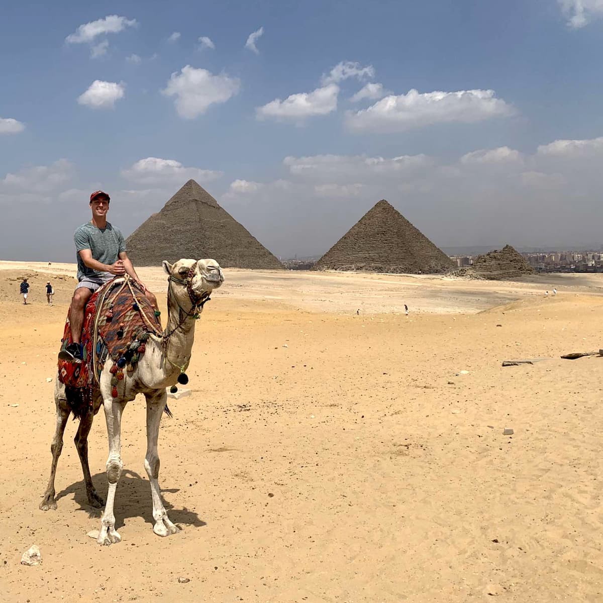 Evan Fagan '22  surveys the pyramids of Giza atop a camel.