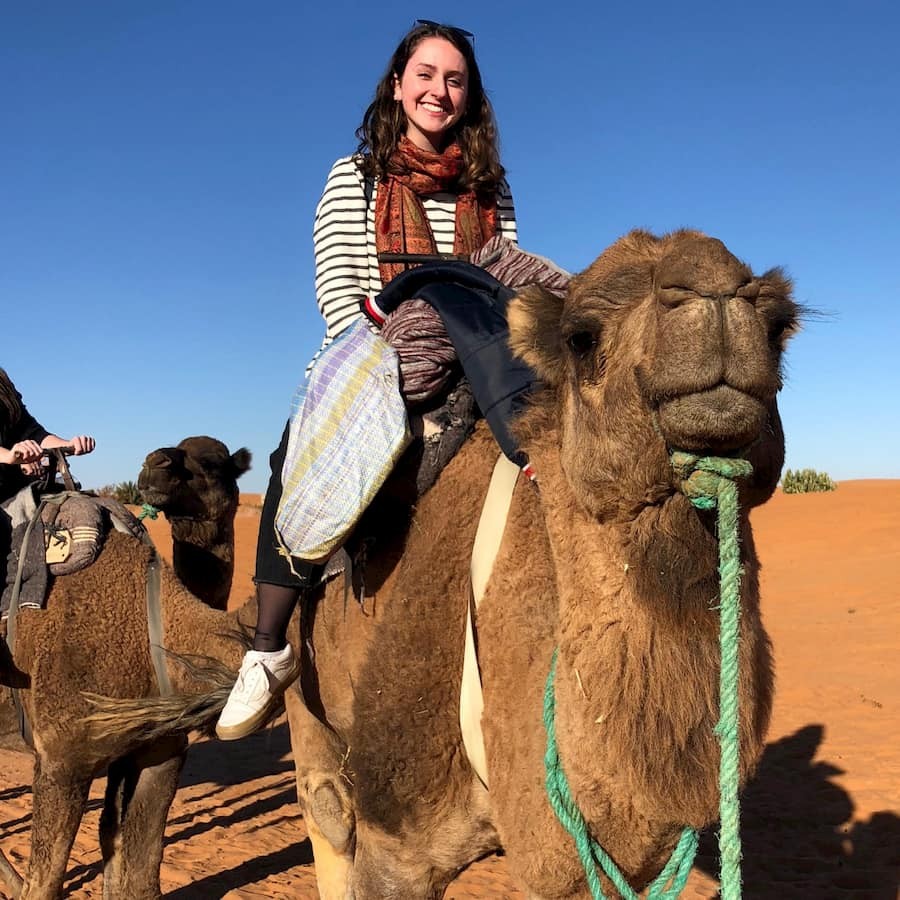 Sarah Engleberg-Nolan '20 rides a camel through the Sahara Desert near Merzouga, Morocco, about 30 miles west of the Algerian border.