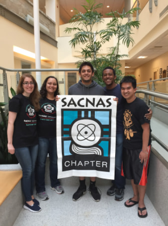 people holding up a SACNAS banner