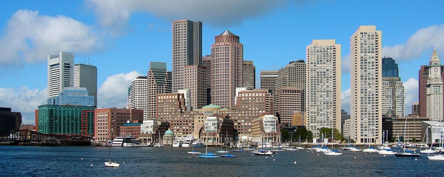 Boston's skyline as viewed from the Harbor, with boats