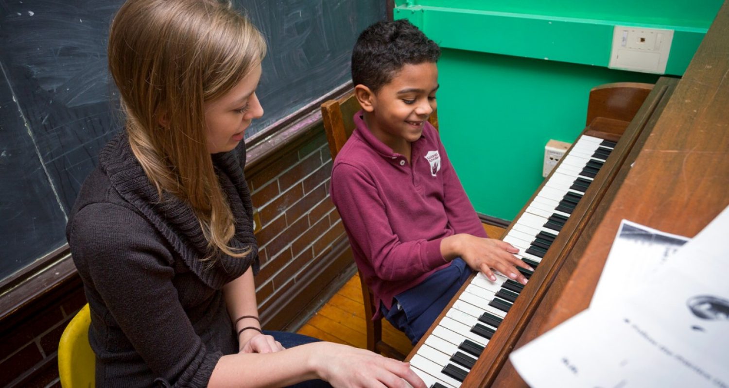 A BC music tutor helps a young student learn piano.