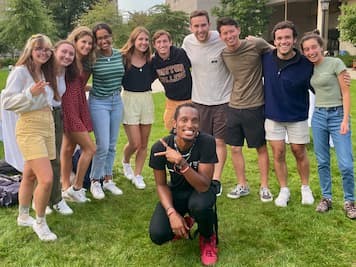 Photo of Image of AY Young posing with students