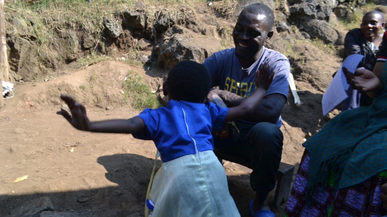 Odille Igirimbabazi dances in front of her father, James Turikumwe.