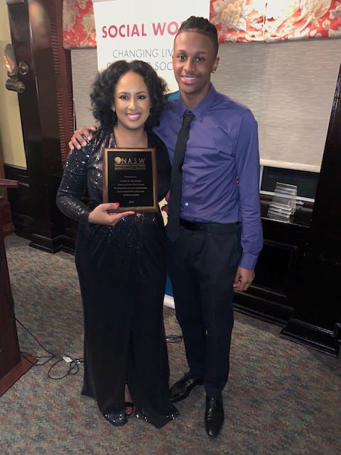 Carla Monteiro (pictured with her son) received the 2019 Future of Social Work Award from NASW.