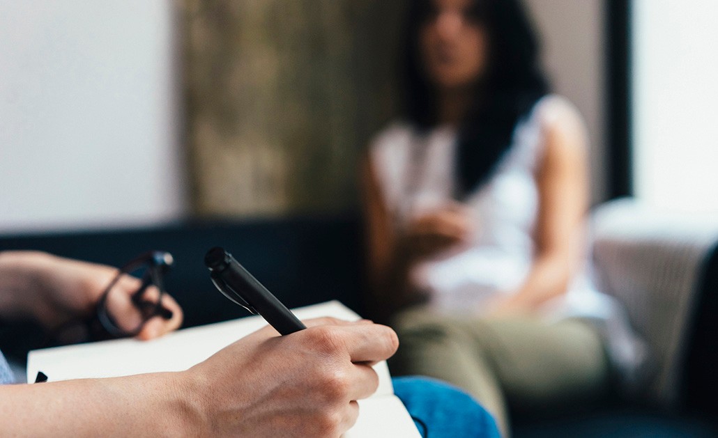 A psychotherapist and her patient talk during a therapy session