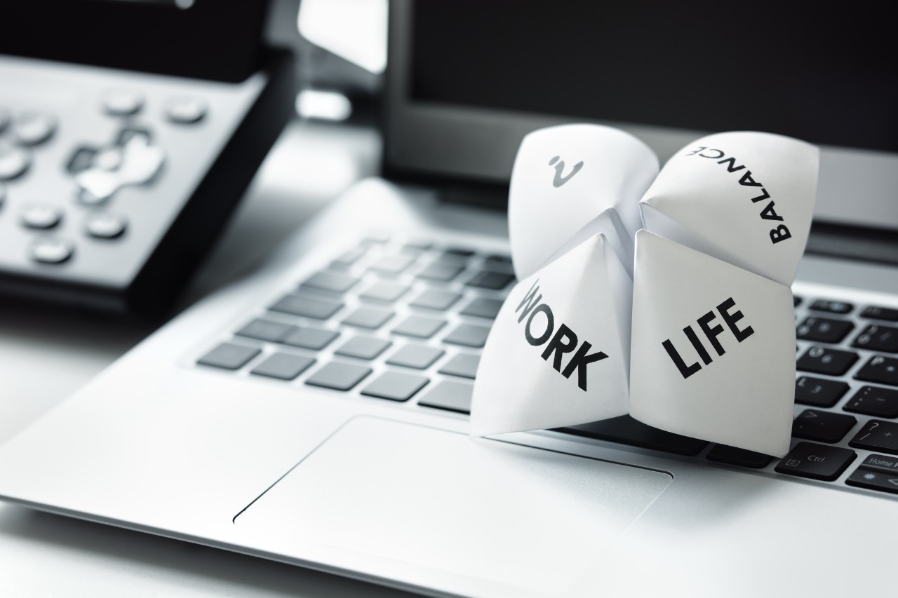 A paper fortune teller rests on a laptop