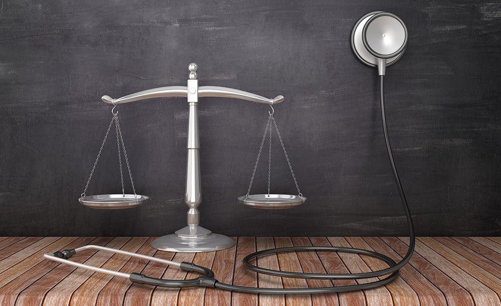 A photo of the scales of justice and a stethoscope