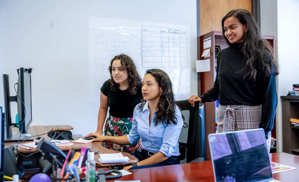 Students and faculty discuss a research project