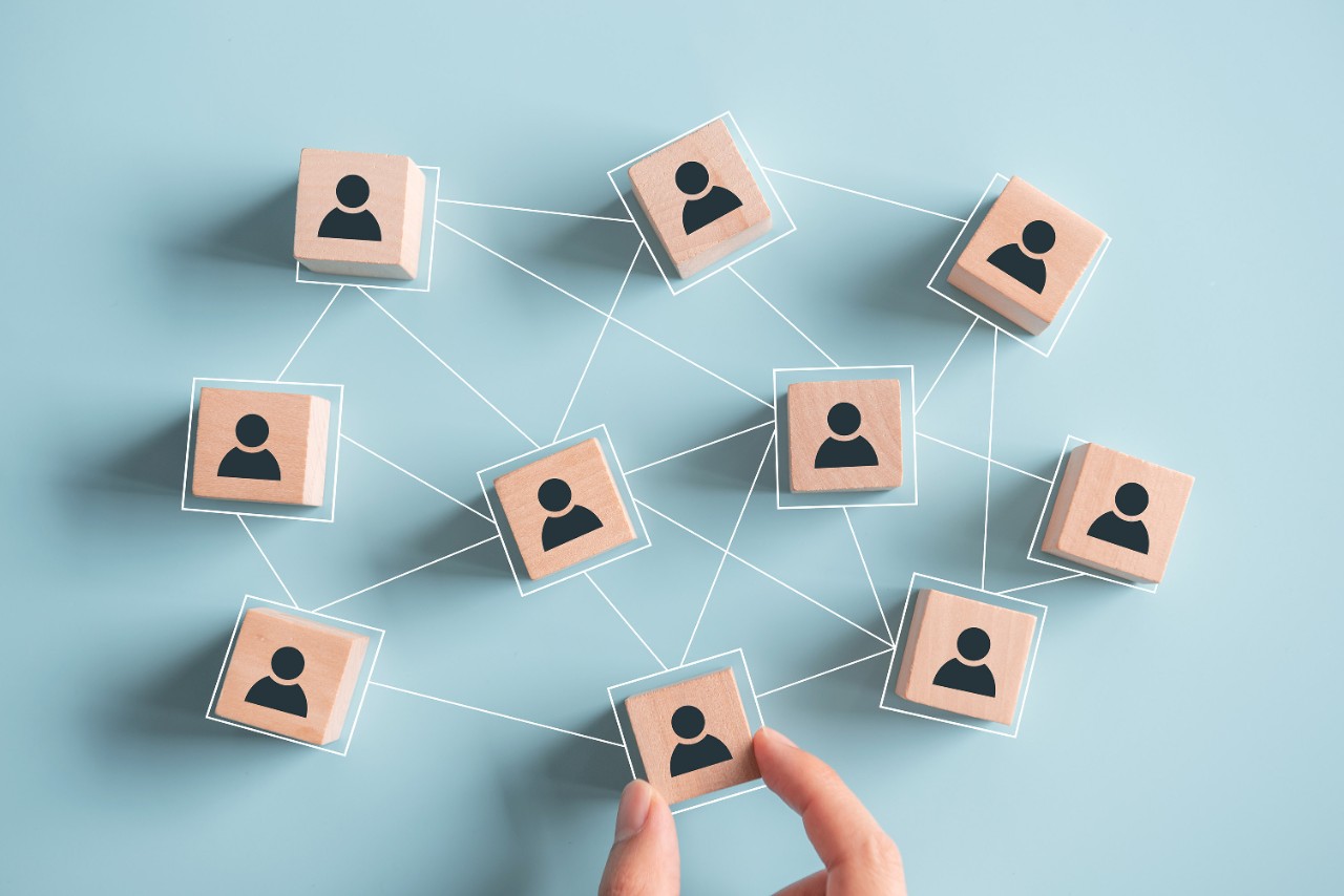 Wooden blocks with people icon on pink background