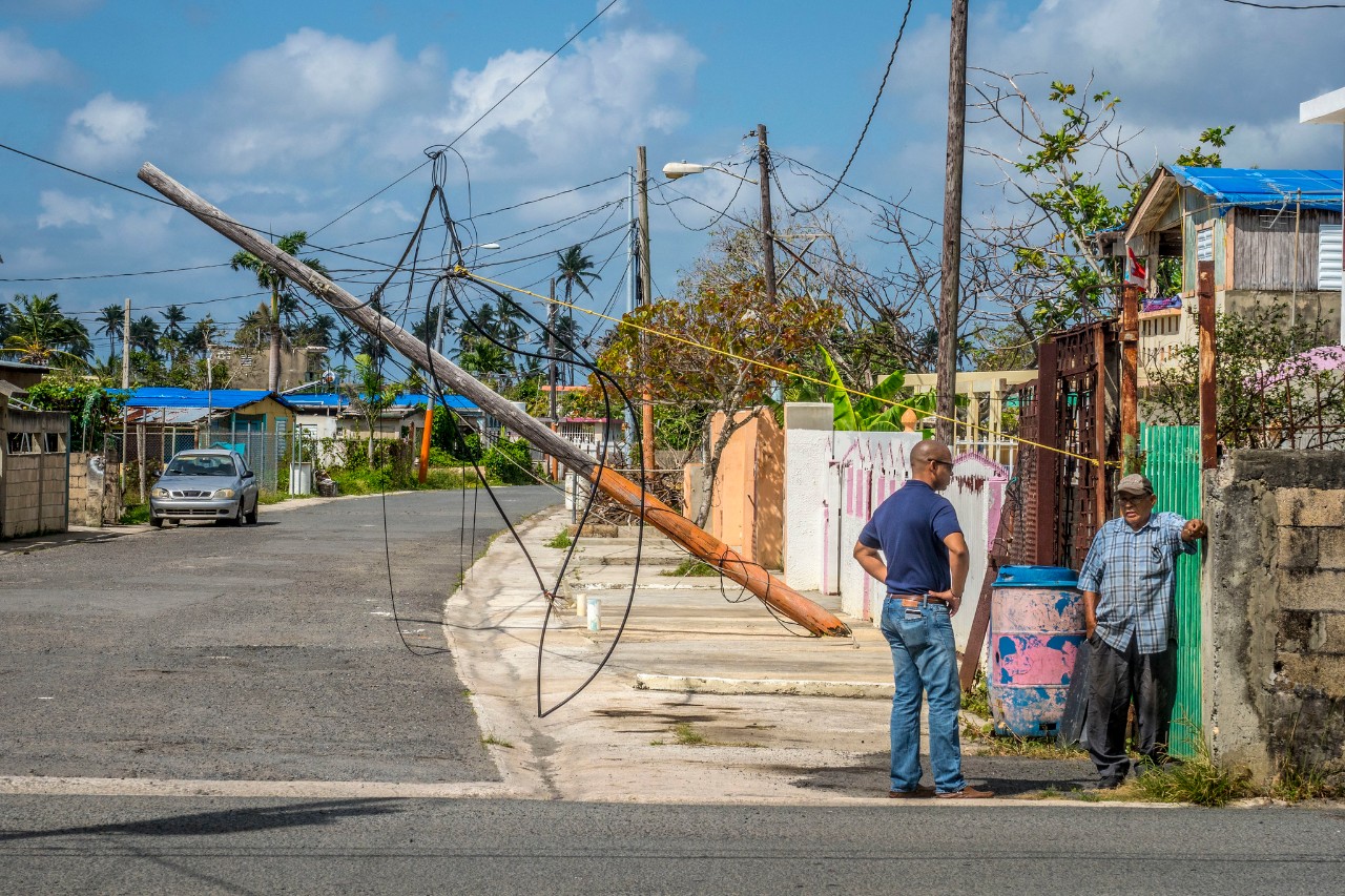 Two people talk on the streets of Puerto Rico after Hurricane Maria