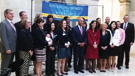 Michael Devon Powell (MSW ’14) stands just to the left of Governor Deval Patrick (photo courtesy the Office of the Governor).