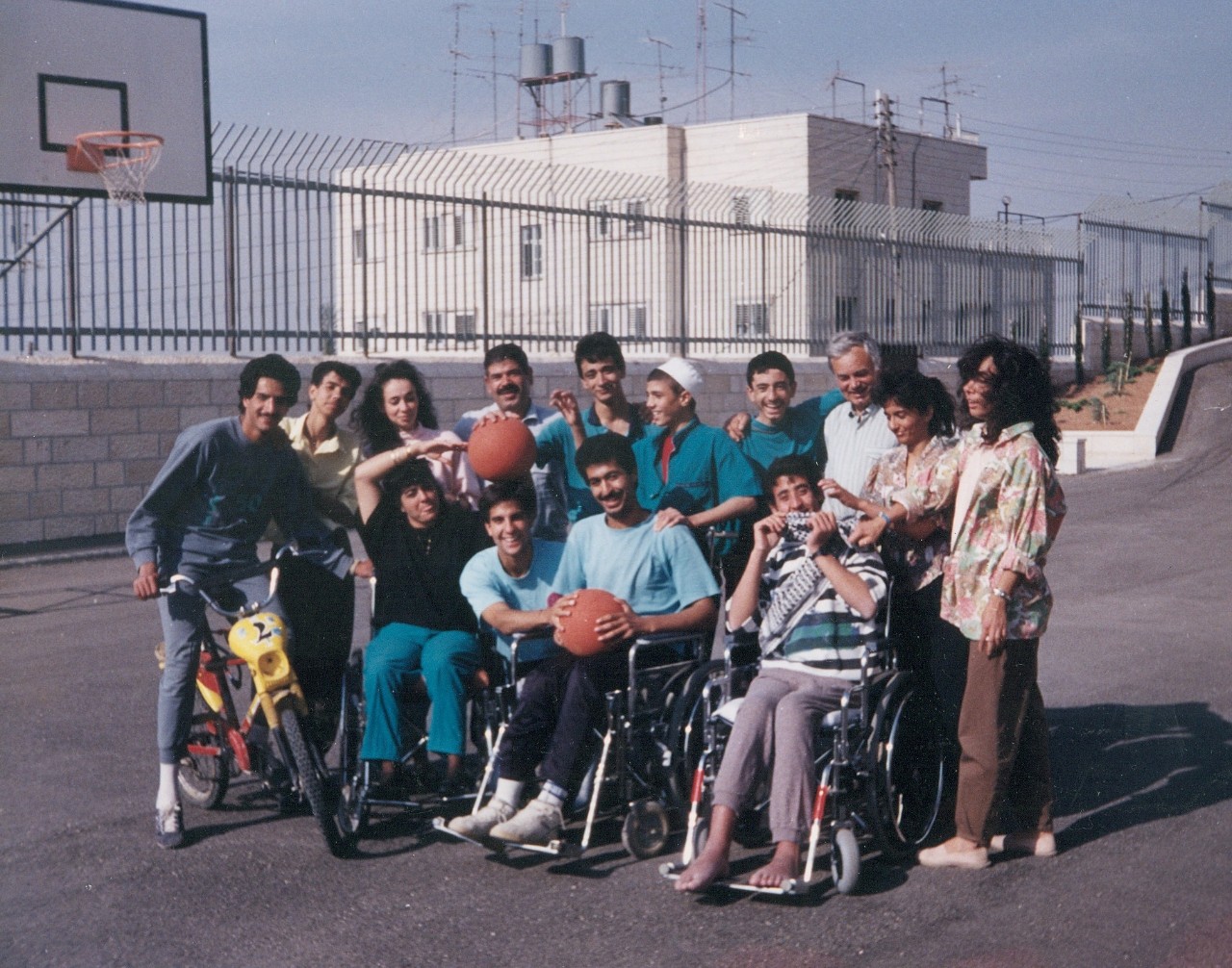 In 1989, Easton (center with right hand on basketball) worked with Palestinian teens with spinal cord injuries at a rehabilitation center near Bethlehem University.