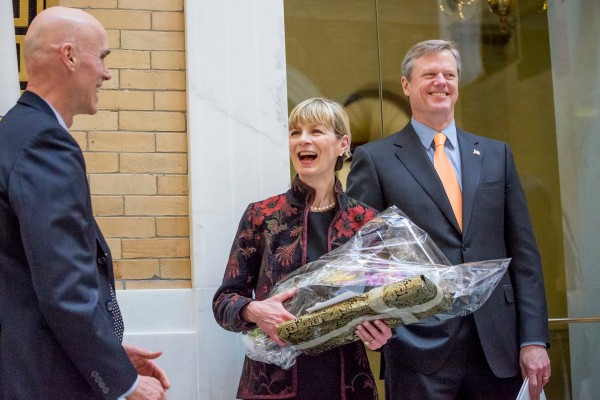 BCSSW Dean Alberto Godenzi presents a gift to Health & Human Services Secretary Marylou Sudders, as Governor Charlie Baker looks on. (Photo courtesy of Caitlin Cunningham)