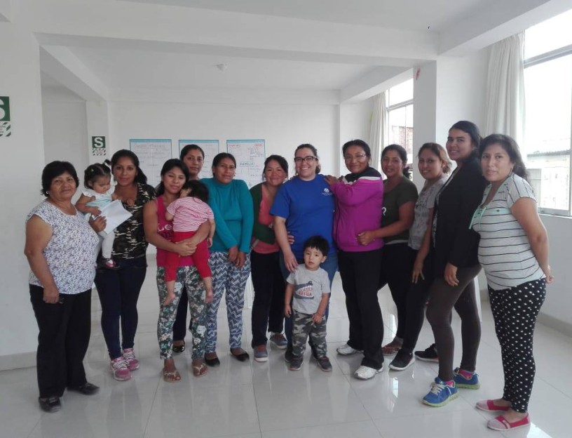 image1-e1526672113329 group of women standing with their children