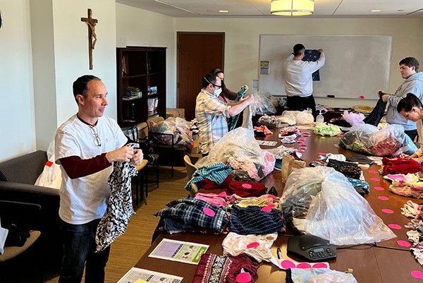 Students sorting clothes at Cradles to Crayons