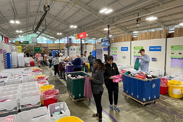 Students sorting clothes at Cradles to Crayons